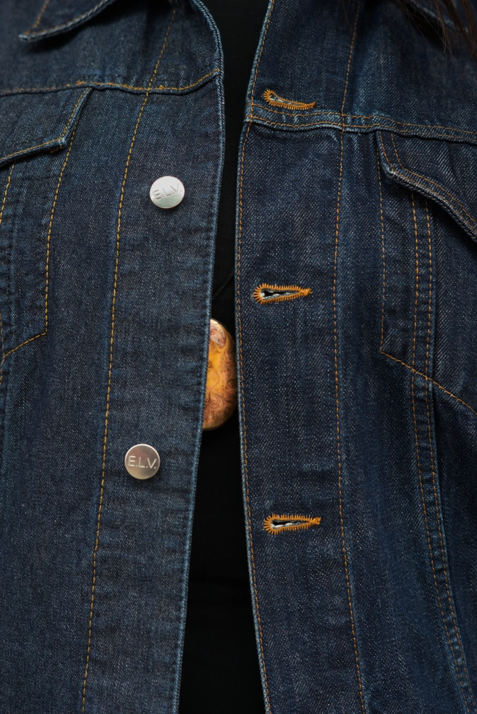 A close up of the jacket, which the 90s model is wearing.
